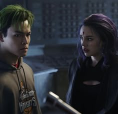 two people standing next to each other with green hair