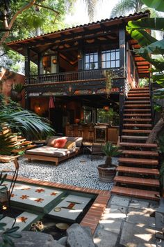 an outdoor living area with steps leading up to the second floor, and plants surrounding it