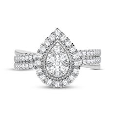 a white gold ring with two rows of diamonds on the band and an oval shaped center diamond