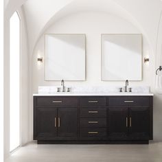 two mirrors are above the double sinks in this bathroom