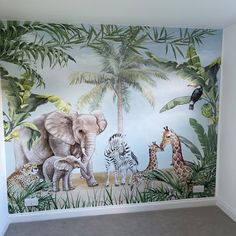 an elephant, giraffes and zebra mural in a child's room