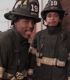 two fire fighters posing for a photo together