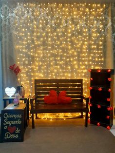 a wooden bench sitting in front of a wall covered with lights and decorations on it