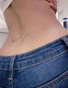 a woman's stomach with the words star girl written on her lower back side