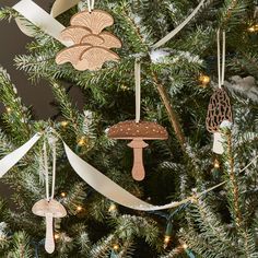 an ornament is hanging on the christmas tree with ribbons and mushrooms in it