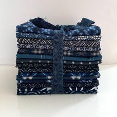 a stack of blue and white cloths sitting on top of each other