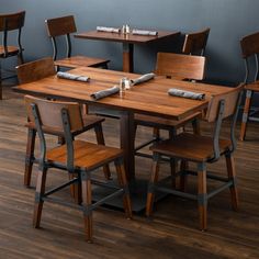 a dining room table and chairs with napkins on them