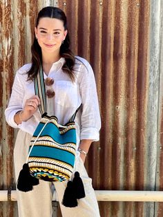 The stunning, one-of-a-kind, 100% handmade crossbody has been carefully crocheted by women from the Wayuu tribe in La Guajira, Colombia. This versatile Wayuu bag is perfect for a night out, running errands, hiking, relax on the weekend, or to take to the gym. It's convenient and light, yet still carries all the essentials. Carefully crafted using a double thread technique for the body. This piece represents approximately 1 week of work for a single artisan. Dimensions: Height: 10.5 inches (27 cm) Width: 8.5 inches  (21.5 cm) Artisan Crochet Tote Bag With Adjustable Strap, Artisan Bag With Adjustable Strap, Hippie Stil, Handmade Crochet Bags, Wayuu Bag, Festival Bag, Sling Bags, Woven Bag, Handmade Fashion