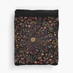 a black background with flowers and leaves in the center duvet cover featuring an image of a