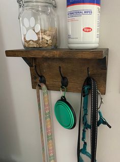 there is a shelf with some items on it and a dog leash hanging from the wall