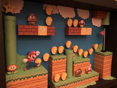 a nintendo themed display with mario and luigi on the top of each block, in front of a blue wall