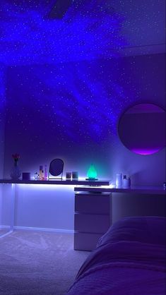 a bedroom with stars on the ceiling and blue lighting