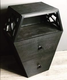 a black wooden box with two drawers on it