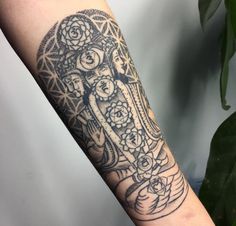 a woman's arm with an intricate tattoo design on the left side of her arm