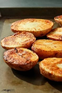 some baked potatoes sitting on top of a pan