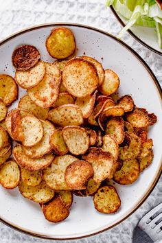 a white plate topped with crispy potato chips