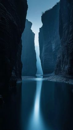 the water is calm and blue as it flows between two large cliffs in the ocean