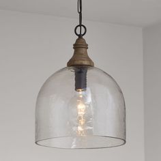 a glass dome light hanging from a ceiling