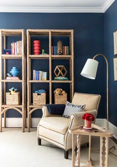 a living room filled with furniture and bookshelves covered in blue wall coverings