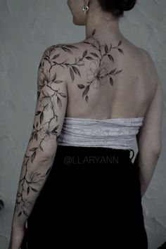 a woman with tattoos on her back and shoulder