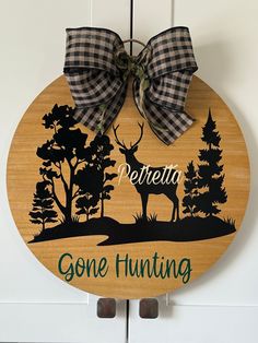 a wooden sign with a bow on it that says,'petrella gone hunting '