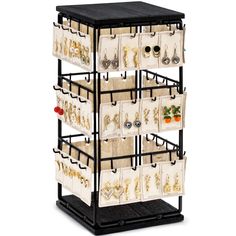 a black and white rack with many different items on it's sides, including earrings