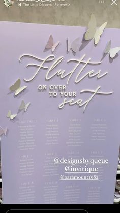 a sign with butterflies on it that says flutterers on over to your seat at an event