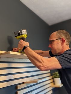 DIY Slat Wall with Shelves - Life with Less Mess Slat Wall Office Organization, Wood Slat Wall With Floating Shelves, Horizontal Slats Wall, Geometric Wall Slats, 1x2 Accent Wall Horizontal, Slate Wall With Shelves, Wooden Slat Wall With Shelves