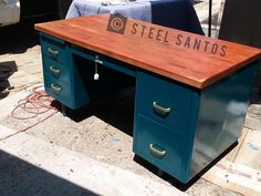 a wooden desk sitting on top of a sidewalk