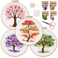 three embroidery kits with colorful trees on them