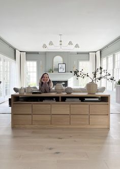 a woman sitting at a table in a living room