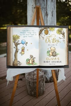 an open book sitting on top of a wooden easel