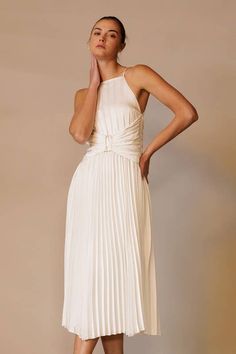 Elevate your formal attire with the Marilyn White Pleated Midi Dress. Featuring an apron neck, modern corset waist, and back tie, this plisse dress adds allure to any event. With its sophisticated design and charming details, you'll feel confident and polished. Perfect for both formal events and cocktail parties. Chic Midi Dress For Banquets, Spring Banquet Dress With Ruched Bodice, Summer Satin Maxi Dress With Pleated Back, Chic A-line Maxi Dress For Banquet, Fitted Bridesmaid Midi Dress With Tie Back, Chic Wedding Maxi Dress With Ruched Bodice, Chic Maxi Length Banquet Dress, Elegant Evening Dress With Pleated Bodice For Spring, Banquet Dresses With Pleated And Fitted Bodice