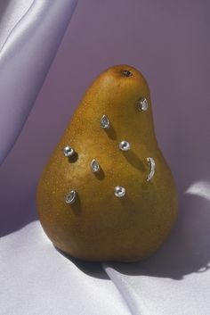 a pear sitting on top of a white cloth