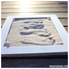 a white frame with footprints in the sand