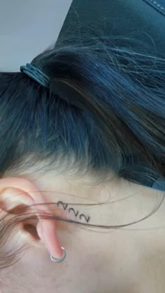 a woman with a tattoo on her ear