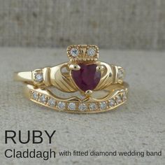 a gold claddagh wedding band with a heart shaped ruby stone in the center