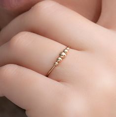 Stay in focus and manage your anxiety and stress with this great fidget ring that will give you relief and calming effects for times when you feel stressed and anxious!  This beautiful fidget spinner ring comes in 14K Gold-Filled and contains 5 cute and small free-moving beads. You can use the gold beads to fidget around with, spin and slide back and forth for meditation and focus, or even if you are just bored. This anxiety spinner ring is also gorgeous and fashionable and suits any fashion sty Fidget Rings, Opal Ring Gold, In Focus, Spinner Ring, Spinner Rings, White Band, Fidget Spinner, Belly Rings, Nose Piercing