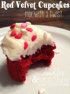 a red velvet cupcake with white frosting and sprinkles on a plate