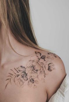 a woman's shoulder with flowers on it, and the back of her chest