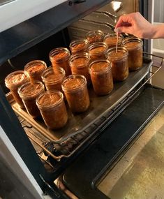 there are many jars of food in the oven