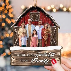 there is no greater gift than family ornament with barn and christmas lights in the background