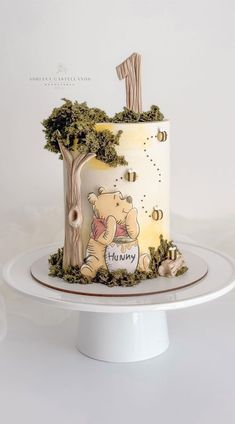 a winnie the pooh birthday cake on a plate