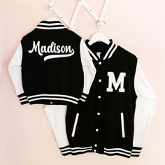 Personalized Kids Varsity Jackets with a custom name on the back make a great gift idea for a little girl or boy playing sports. Get it for your little one that is in little leagues or flag football. Each black varsity jacket has white sleeves, a knitted collar, cuffs, and a waistband with striped details, and press-stud closure buttons. Jackets have a chenille patch in the monogram or number of your choice. Choose to have a custom name or word on the back for an additional cost.  ★DETAILS★ Listing is for 1 CHILD SIZE VARSITY JACKET with front patch of your choice and an option for custom text on the back. Fabric - 9.8 oz., 80% ringspun cotton, 20% polyester heavyweight fabric CARE INSTRUCTIONS:  Cold wash on gentle cycle. Hang Dry. Do NOT Bleach. Iron Medium Temperature. NO RETURNS OR EXC Highschool Jacket, Highschool Senior, Black Varsity Jacket, Custom Varsity Jackets, Senior Student, White Sleeves, Chenille Patch, Knitted Collar, Varsity Jackets