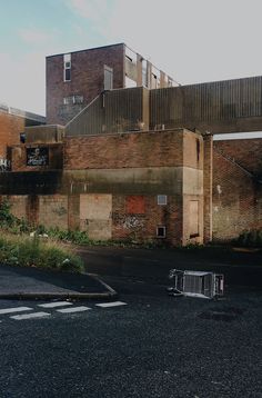 an empty parking lot in front of some buildings