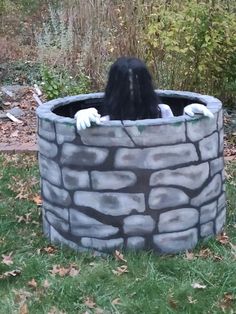 a woman in a stone bathtub with her hands on the edge and head sticking out