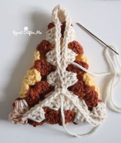 a crocheted christmas tree ornament with yarn