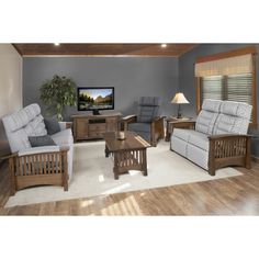 a living room filled with furniture and a flat screen tv on top of a wall