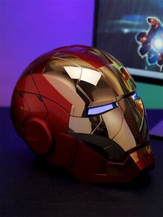 the iron man helmet is next to a computer monitor