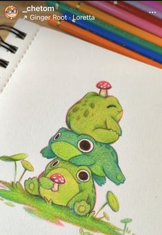 a drawing of two green monsters sitting on top of each other in front of colored pencils